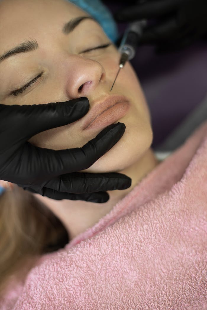 Close-up view of a cosmetic lip injection procedure performed by a professional.